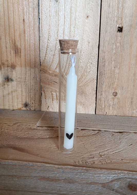 Kaars in glazen buisje met een zwart hartje op